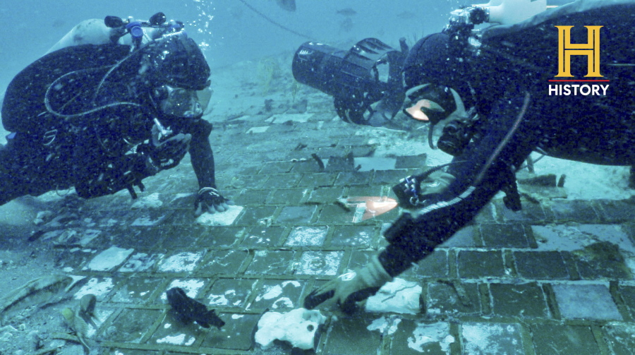 In this photo provided by the HISTORY(R) Channel, underwater explorer and marine biologist Mike Barnette and wreck diver Jimmy Gadomski explore a 20-foot segment of the 1986 Space Shuttle Challenger that the team discovered in the waters off the coast of Florida during the filming of The HISTORY(R) Channel's new series, "The Bermuda Triangle: Into Cursed Waters," premiering Tuesday, Nov. 22, 2022.
