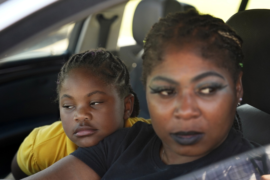 Mitoya Wilson sits in her car with her daughter Charleigh Wilson, 8, as she talks about the history of troubles with the town drinking water, in Ferriday, La., Tuesday, Sept. 13, 2022.  In many places, people struggle to find water or else drink water that isn't clean.