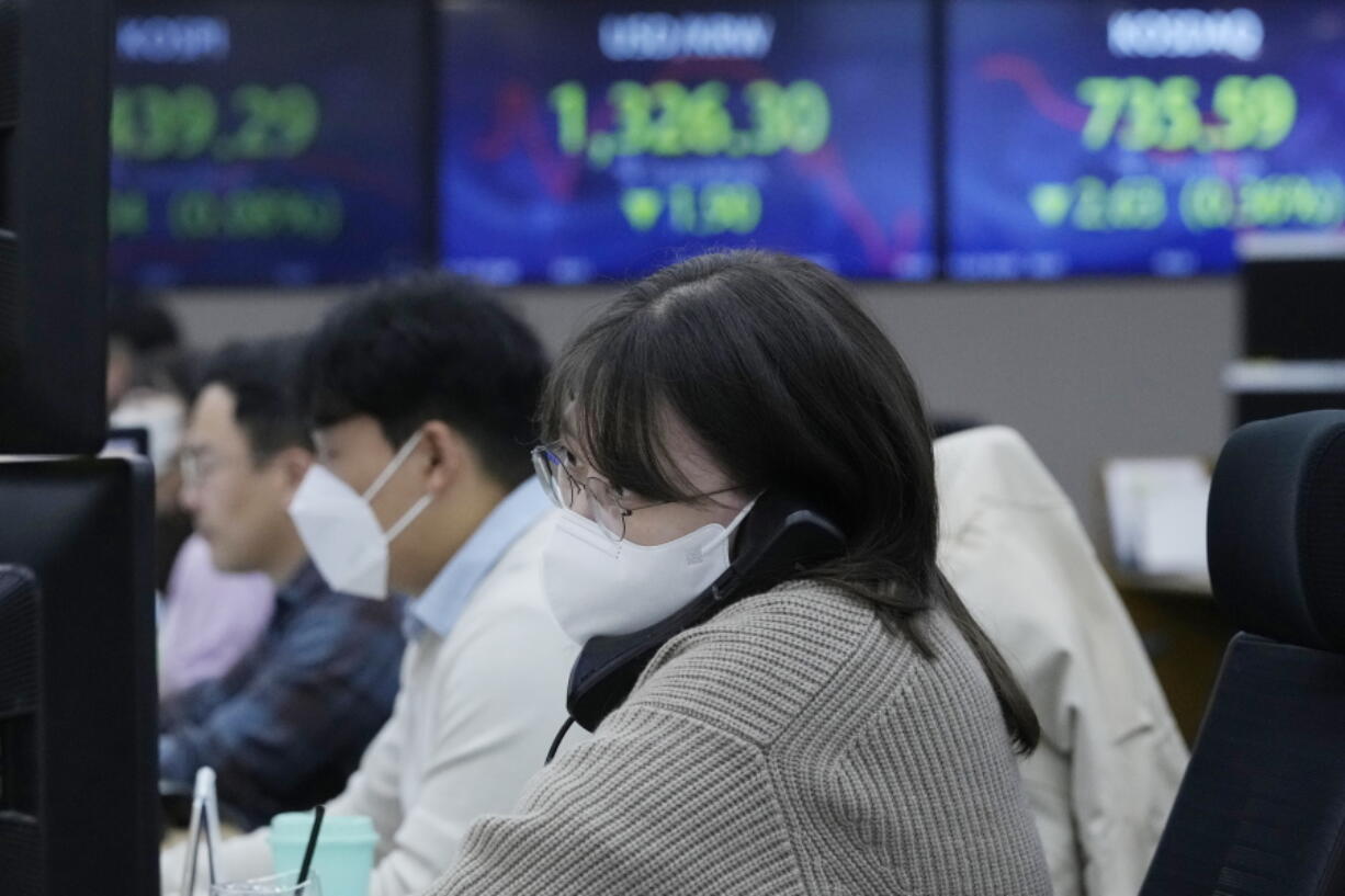 A currency trader watches monitors at the foreign exchange dealing room of the KEB Hana Bank headquarters in Seoul, South Korea, Friday, Nov. 25, 2022. Asian shares were mixed Friday as worries deepened about the regional economy and Japan reported higher-than-expected inflation.