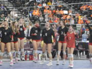 The Camas bench celebrates a point in a quarterfinal match of the Class 4A state volleyball tournament on Friday, Nov. 18, 2022 in Yakima.