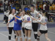 The Ridgefield volleyball team gathers after a point against Sedro-Woolley in a first-round match of the Class 2A state volleyball tournament on Friday, Nov. 18, 2022 in Yakima.