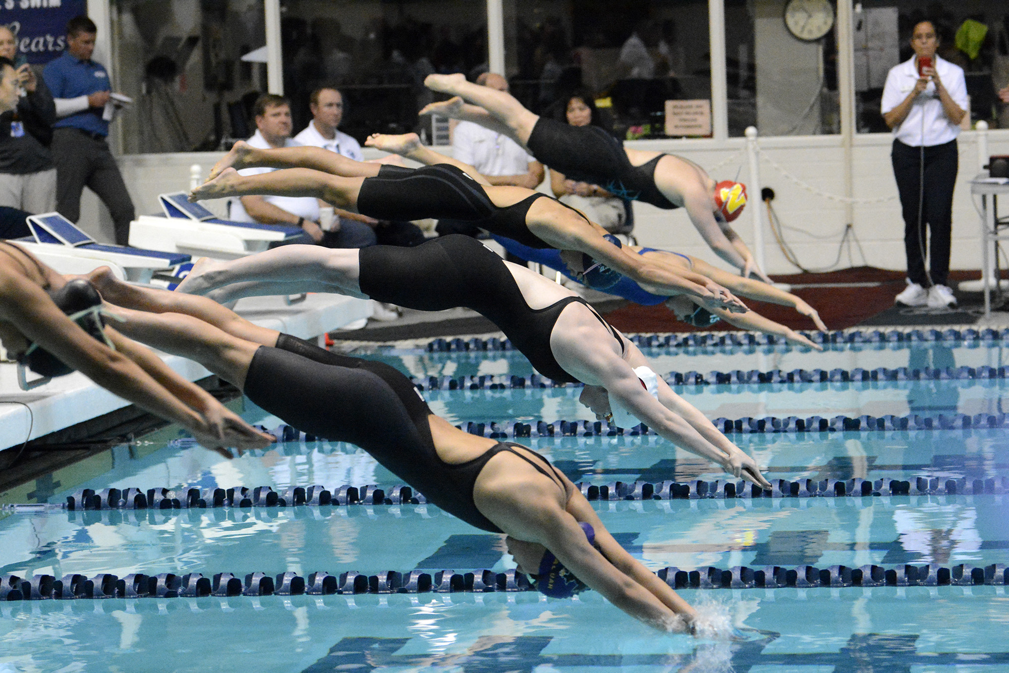 Campbell Deringer of Camas (center, white cap) takes off at the 4A final of the 100 breaststroke at the state swim meet at Federal Way on Saturday, Nov. 12, 2022.