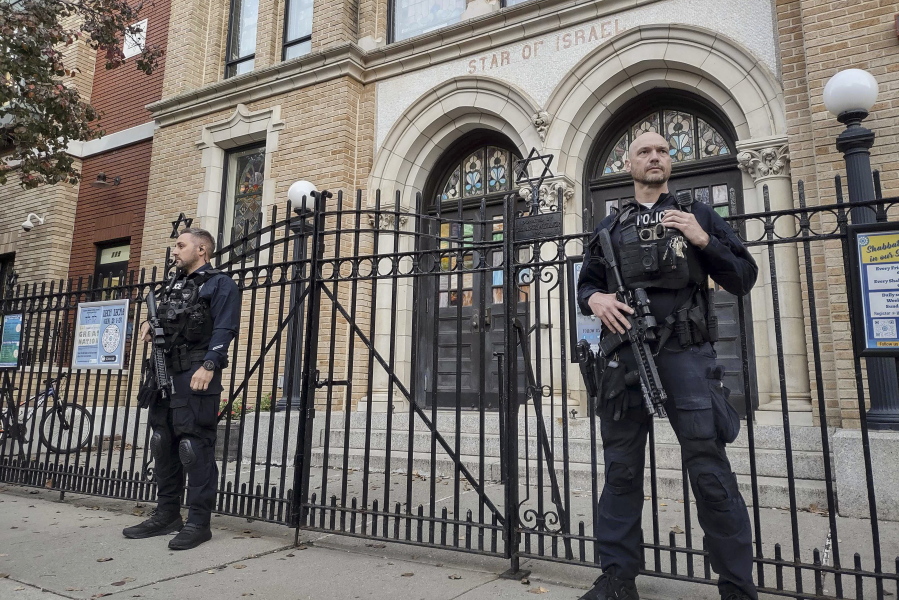 Hoboken Police officers stand watch outside the United Synagogue of Hoboken, Thursday, Nov. 3, 2022, in Hoboken, N.J. The FBI says it has received credible information about a threat to synagogues in New Jersey. The FBI's Newark office released a statement Thursday afternoon that characterizes it as a broad threat.