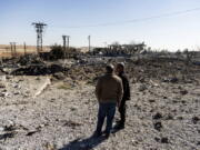 FILE -- People look at a site damaged by Turkish airstrikes that hit an electricity station in the village of Taql Baql, in Hasakeh province, Syria, Sunday, Nov. 20, 2022. Turkish airstrikes on northern Syria over the weekend that killed and wounded a number of Syrian soldiers could pose a setback to the recent move toward a rapprochement between the two countries after 11 years of tension and hostility.