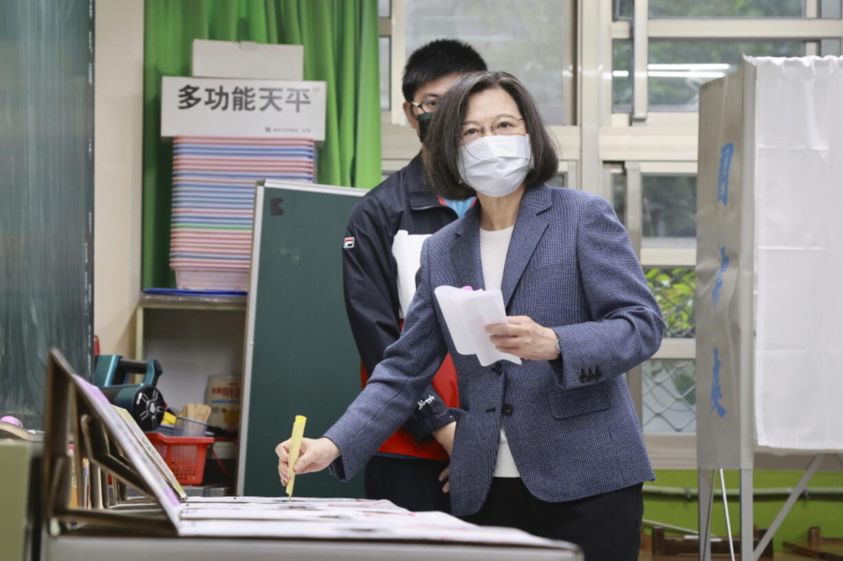Taiwan President Tsai Ing-wen casts her ballots at a polling station in New Taipei City, Taiwan, Saturday, Nov. 26, 2022. Voters headed to the polls across Taiwan in a closely watched local election Saturday that will determine the strength of the island's major political parties ahead of the 2024 presidential election.