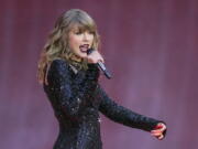 FILE - Singer Taylor Swift performs on stage in a concert at Wembley Stadium on June 22, 2018, in London. On the heels of a messy ticket roll out for Swift's first tour in years, fans are angry; they're also energized against Ticketmaster. While researchers agree that there's no way to tell how long the energy could last, the outrage shows a way for young people to become more politically engaged through fan culture.