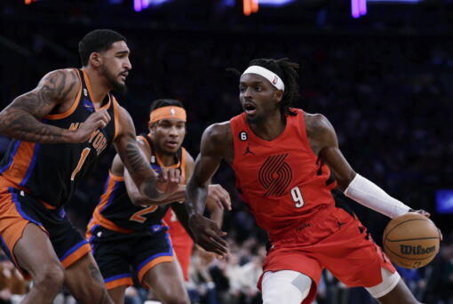 Portland Trail Blazers forward Jerami Grant (9) drives against New York Knicks forward Obi Toppin during the first half of an NBA basketball game Friday, Nov. 25, 2022, in New York.
