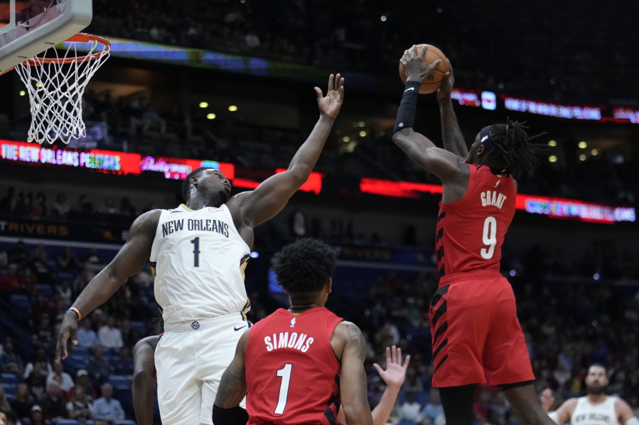 New Orleans Pelicans forward Zion Williamson (1) reaches for a rebound held by Portland Trail Blazers forward Jerami Grant (9) during the first half of an NBA basketball game in New Orleans, Thursday, Nov. 10, 2022.
