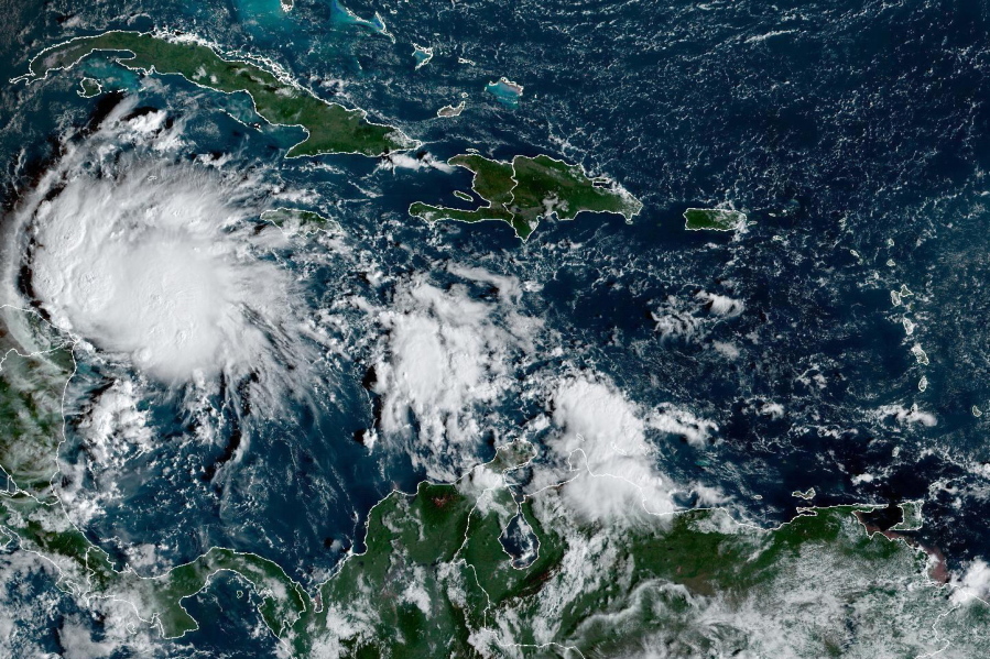 This satellite image taken at 8:40am ET and provided by NOAA shows Tropical Storm Lisa under Cuba in the Caribbean Sea, Tuesday, Nov. 1, 2022. Lisa is forecast to make landfall in Central America later in the week as a likely hurricane.