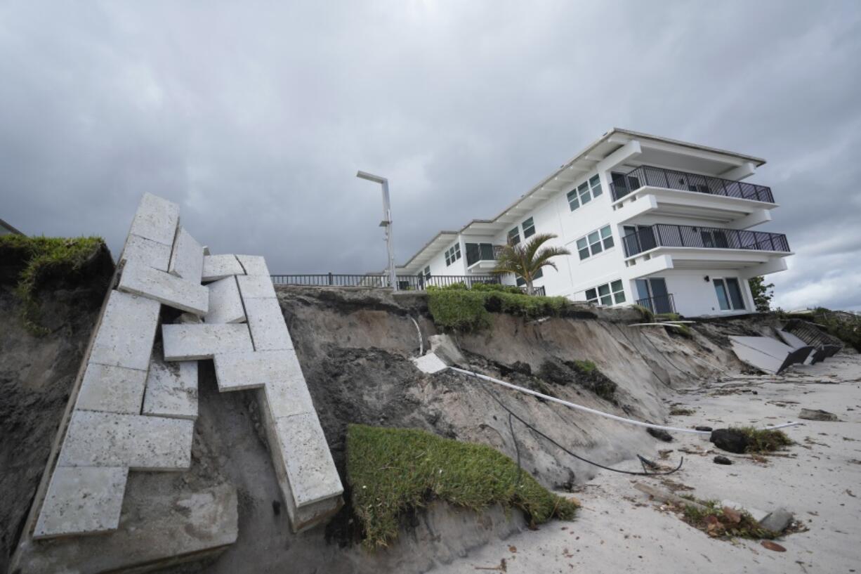 Condominium amenities and a unit terrace lie toppled onto the beach after the sand below was swept away, following the passage of Hurricane Nicole, Thursday, Nov. 10, 2022, at Ocean Club Condominiums in Vero Beach, Fla.