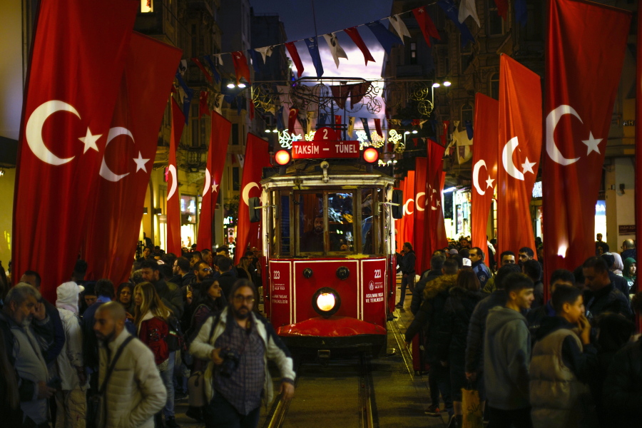 A tram rides past the spot of Sunday's explosion on Istanbul's popular pedestrian Istiklal Avenue in Istanbul, Turkey, Monday, Nov. 14, 2022.Turkish police said Monday they have detained a Syrian woman with suspected links to Kurdish militants and that she confessed to planting a bomb that exploded on a bustling pedestrian avenue in Istanbul, killing six people and wounding several dozen others.