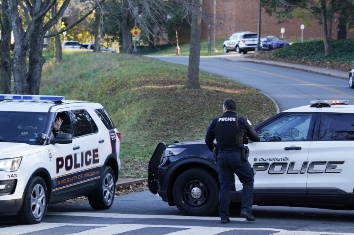 Charlottesville police secure a crime scene of an overnight shooting at the University of Virginia, Monday, Nov. 14, 2022, in Charlottesville. Va.