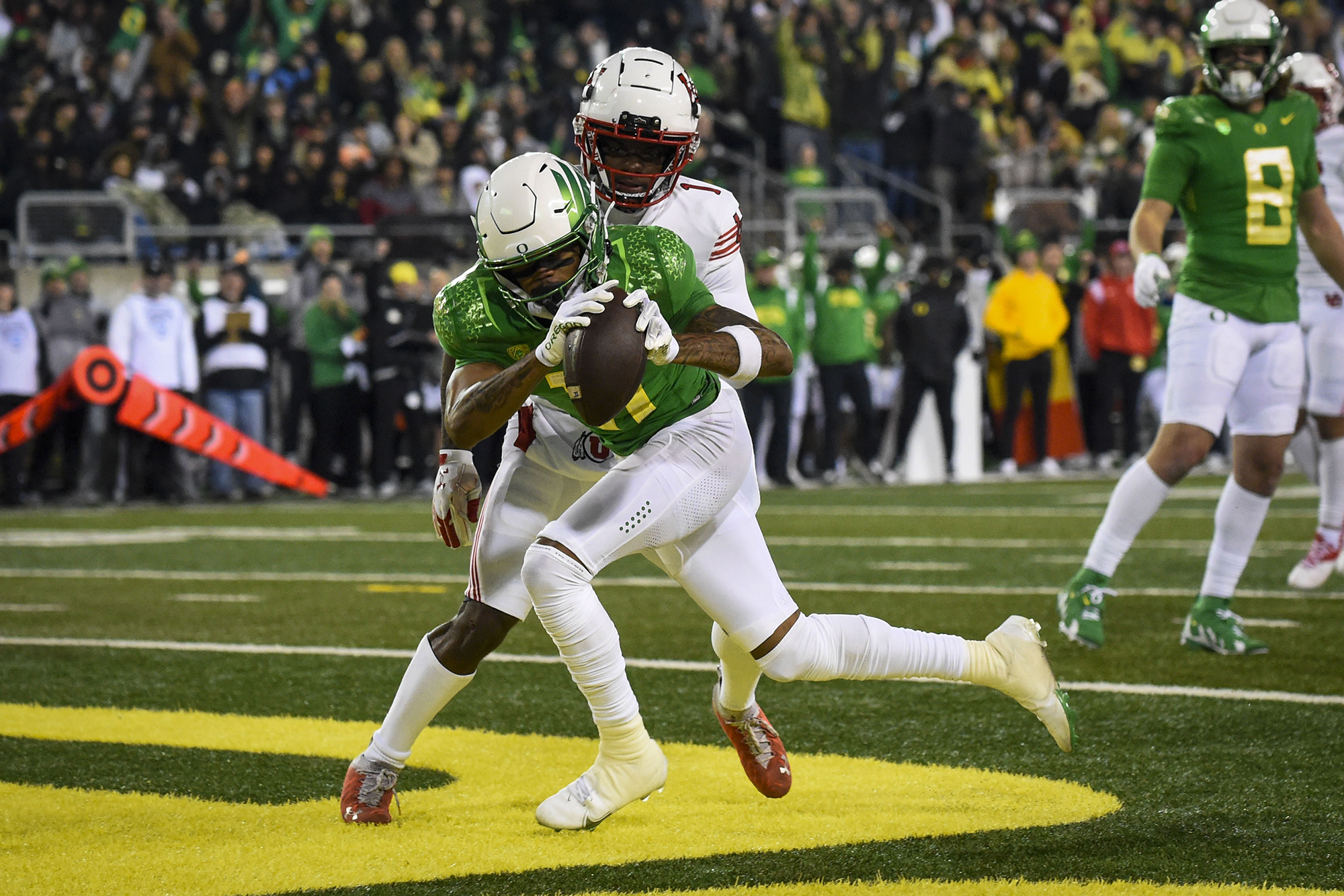 Oregon wide receiver Troy Franklin (11) hauls in a touchdown pass in front of Utah cornerback Clark Phillips III (1) during the first half of an NCAA college football game Saturday, Nov. 19, 2022, in Eugene, Ore.