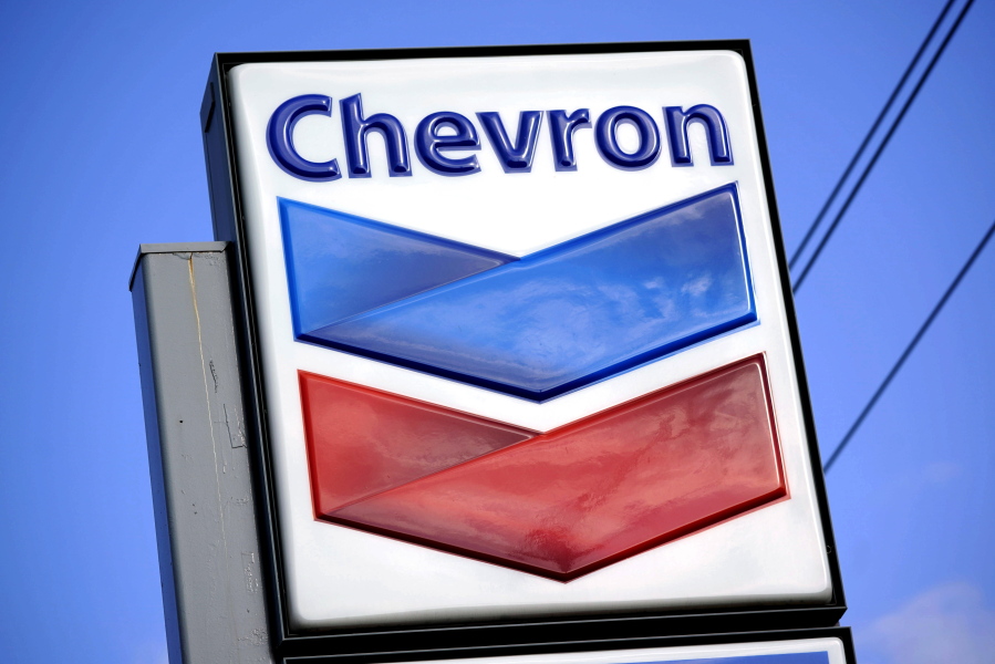 FILE - A Chevron sign is displayed outside one of the company's gas stations in Bradenton, Fla., Feb. 22, 2022. The Biden administration is easing some oil sanctions on Venezuela in an effort to support newly restarted negotiations between the Venezuelan government and its opposition. The Treasury Department is allowing Chevron to resume "limited" energy production in Venezuela after years of sanctions that have dramatically curtailed oil and gas profits that have flowed to President Nicol?s Maduro's government. (AP Photo/Gene J.