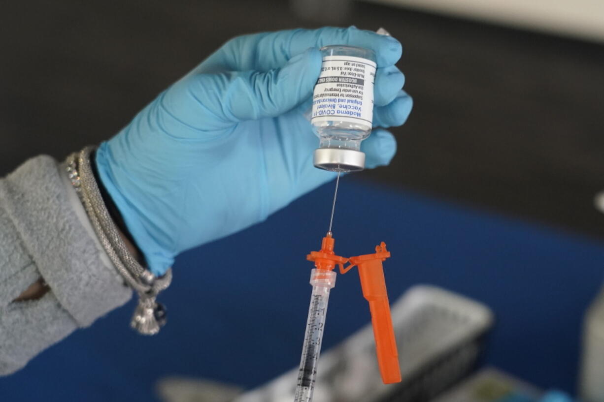 A Jackson-Hinds Comprehensive Health Center nurse loads a syringe with a Moderna COVID-19 booster vaccine at an inoculation station next to Jackson State University in Jackson, Miss., Friday, Nov. 18, 2022. Moderna recently announced early evidence that its updated booster induced BQ.1.1-neutralizing antibodies. (AP Photo/Rogelio V.
