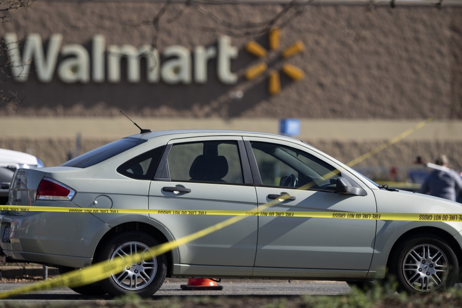 Crime scene tape surrounds a car at the scene of a mass shooting at a Walmart, Wednesday, Nov. 23, 2022, in Chesapeake, Va.  A Walmart manager opened fire on fellow employees in the break room of the Virginia store, killing several people in the country's second high-profile mass shooting in four days, police and witnesses said Wednesday.