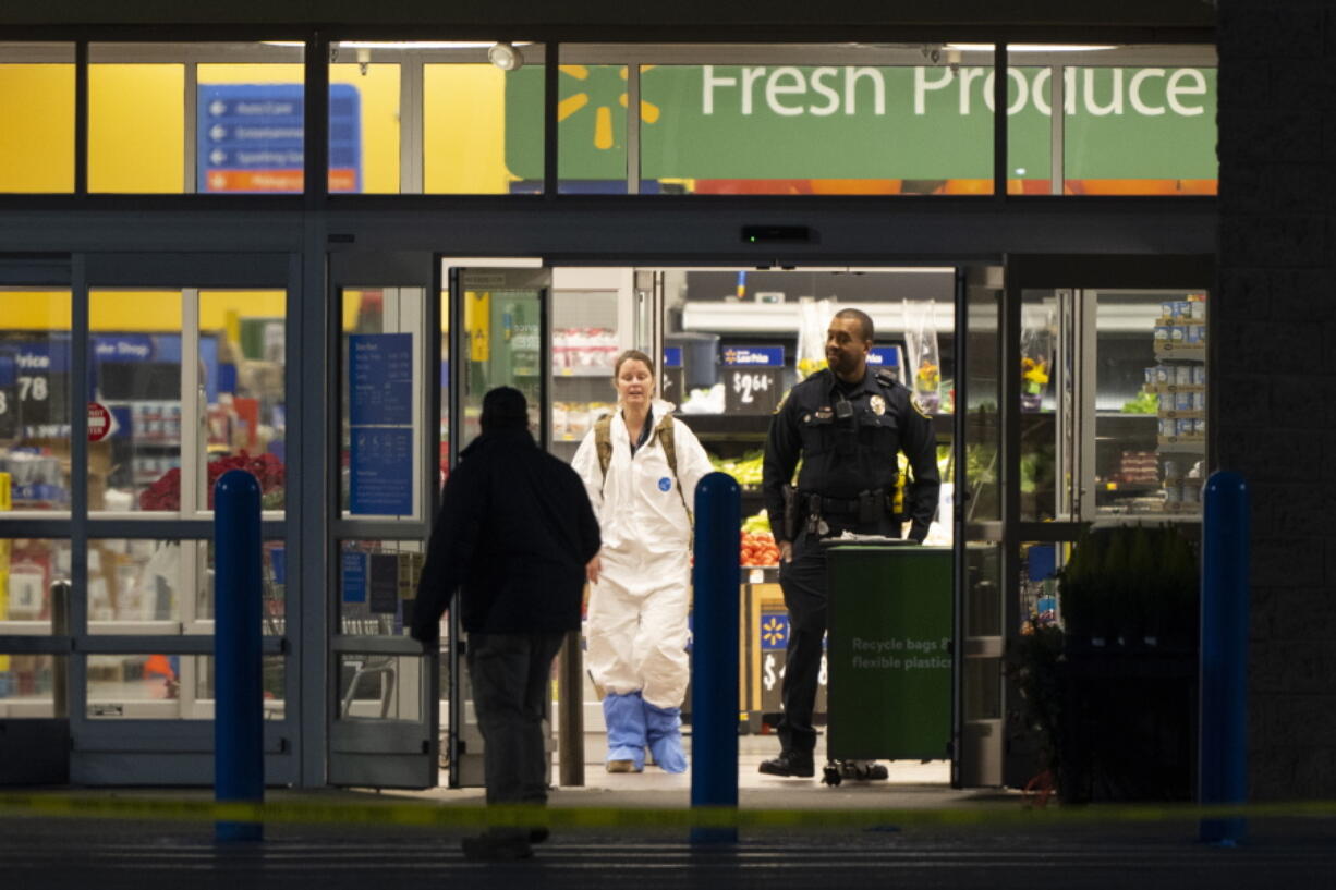 A law enforcement investigator wears a protective covering as they work the scene of a mass shooting at a Walmart, Wednesday, Nov. 23, 2022, in Chesapeake, Va.