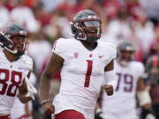 Washington State quarterback Cameron Ward (1) celebrates after throwing a touchdown against Stanford during the first half of an NCAA college football game in Stanford, Calif., Saturday, Nov. 5, 2022. (AP Photo/Godofredo A.
