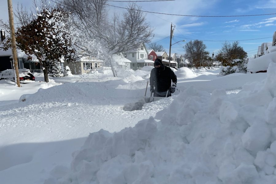 Martin Haslinger uses a snowblower outside his home in Buffalo, N.Y.,  on Saturday, Nov. 19, 2022 following a lake-effect snowstorm.  Residents of northern New York state are digging out from a dangerous lake-effect snowstorm that had dropped nearly 6 feet of snow in some areas and caused three deaths. The Buffalo metro area was hit hard, with some areas south of the city receiving more than 5 feet by early Saturday.