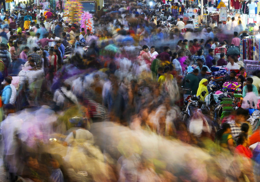 People move through a market in Mumbai, India, Saturday, Nov. 12, 2022. The world's population is projected to hit an estimated 8 billion people on Tuesday, Nov. 15, according to a United Nations projection.