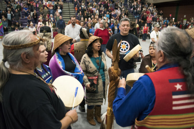 Sam Robinson's granddaughter, Destany Reeves-Robinson, and his wife, Mildred, join in a Chinook Blessing Song during the 2018 Annual Traditional Pow Wow at Heritage High School in Vancouver.