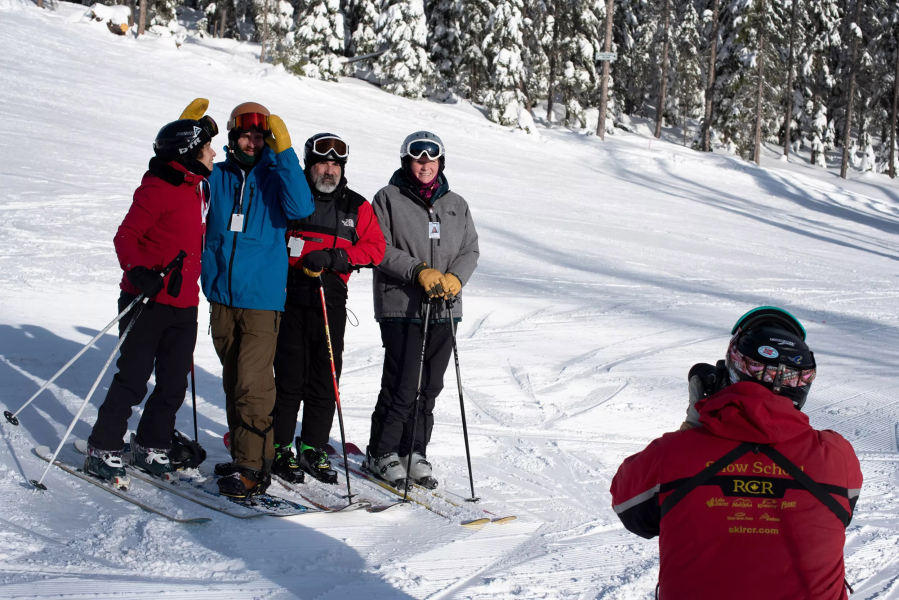 Mathew Sawyer, the communications director for Lookout Pass, takes a photo of some of the first four riders up the new Eagle Peak chairlift on Dec. 17, 2022. The total vertical descent from the top of the new chair is 1,650 feet.