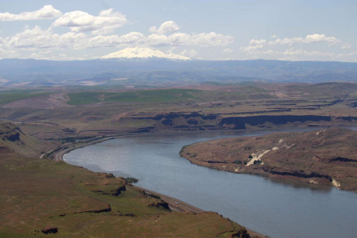 FILE - In this June 3, 2011, file photo, the Columbia River flows near the John Day Dam, east of the city of The Dalles, Ore.  The entire congressional delegation from Washington, Oregon, Idaho and Montana is demanding that the Obama administration begin negotiations with Canada to re-authorize the landmark Columbia River Treaty. The updating of the treaty affects the economy, environment, and flood control needs of millions of residents of the four states along more than 1,200 miles of the Columbia River and its tributaries, they contend.