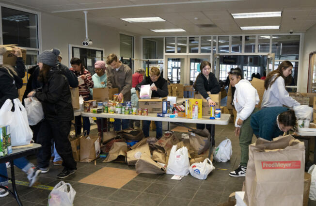 A diverse cast of volunteers, from high school students to retired folk, sort through nonperishable food and goods donated by local residents for the annual Walk & Knock campaign in Vancouver on Saturday.
