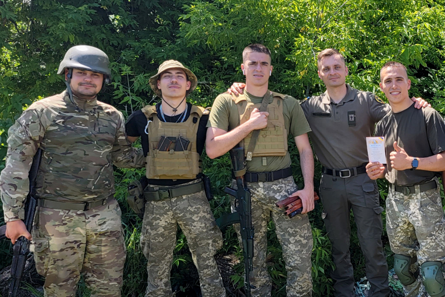 Volunteer military chaplain and Vancouver resident Mikhail Pavenko, fourth from left, visiting Ukrainian troops in the Kharkiv region in summer 2022. The soldier farthest left, in helmet, died three days later when a mortar hit his position, Pavenko said.
