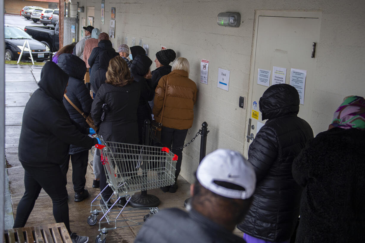 A line of people in need wait to shop for groceries at FISH of Vancouver on Dec. 8.