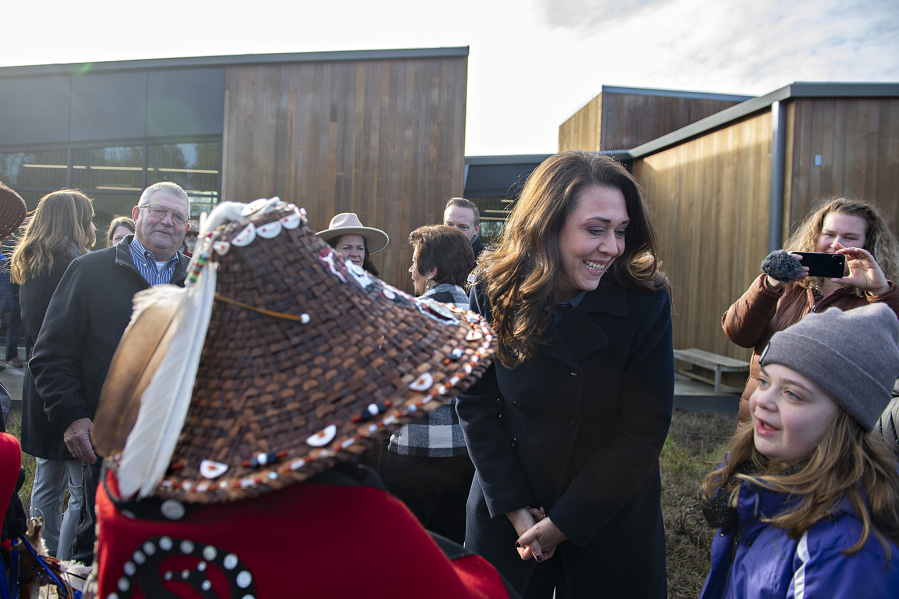 Rep. Jaime Herrera Beutler, second from right, joins her daughter, Abigail, 9, as they talk with members of the Cowlitz Indian Tribe at the ribbon -cutting for the new Ridgefield National Wildlife Refuge administration building Friday morning.