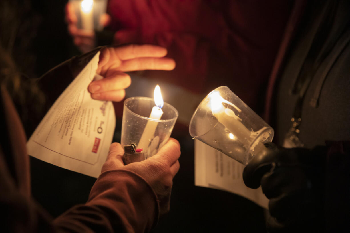 ELAYNA YUSSEN for The Columbian
Attendees light candles at the annual Homeless Persons Memorial Day on Dec. 21 in Vancouver. Homelessness is a persistent top story in Clark County.