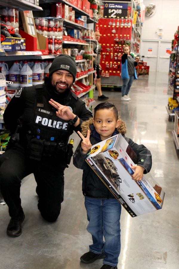 On Dec. 3, 10 Battle Ground police officers accompanied 19 local children on a shopping spree as they bought gifts for their loved ones and items for themselves.