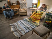 Jene McMahon, right, crochets the temperature blanket she's been making all year while chatting with her husband, Tom, who happens to work as a heating technician. "We finally have something to talk about every evening!" Jene McMahon said.