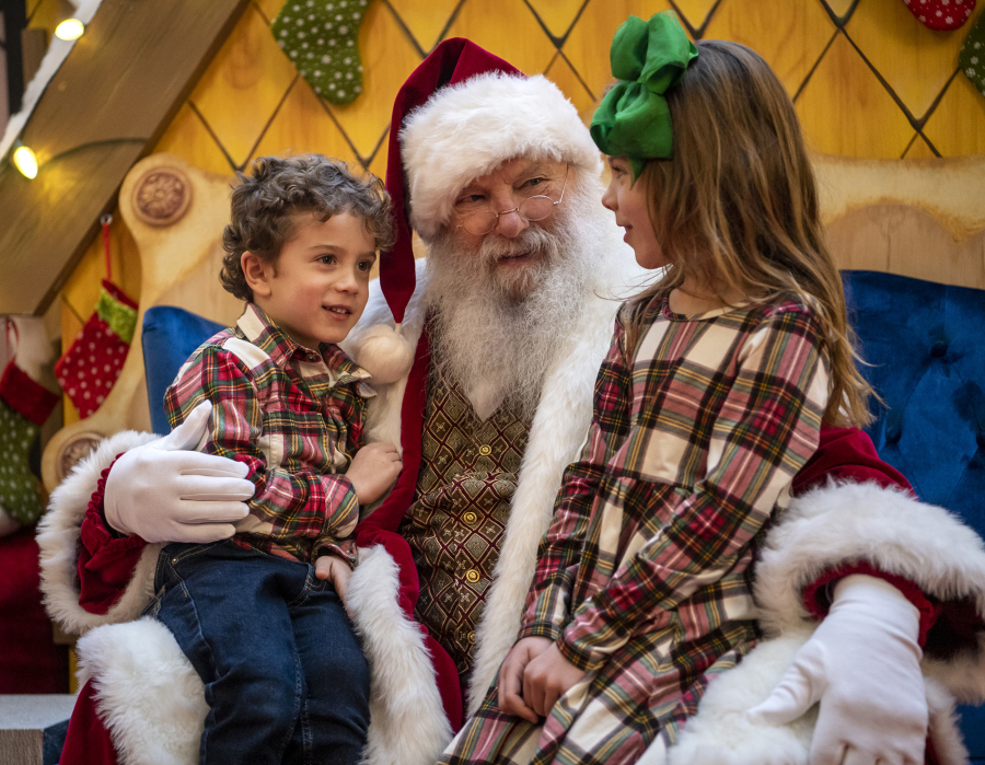Santa Claus, center, listens to what Luciana, 6, right, and Roman Sereno, 4, both of Battle Ground, want for Christmas at the Vancouver Mall. Legos have been a popular ask from children this year, along with Barbies, Nintendo Switches and the occasional yo-yo.