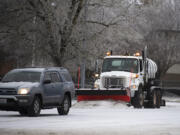 A snowplow tackles frozen roads in east Vancouver on Friday morning, Dec. 23, 2022.