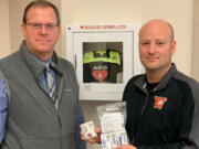 Washougal School District assistant superintendent Aaron Hansen, left, and Washougal High School principal Mark Castle display a dose of Narcan, a medication used to assist people who have experienced an overdose of opioids. The Washougal School Board recently approved a policy that states that Narcan will be placed in every one of the district's schools.