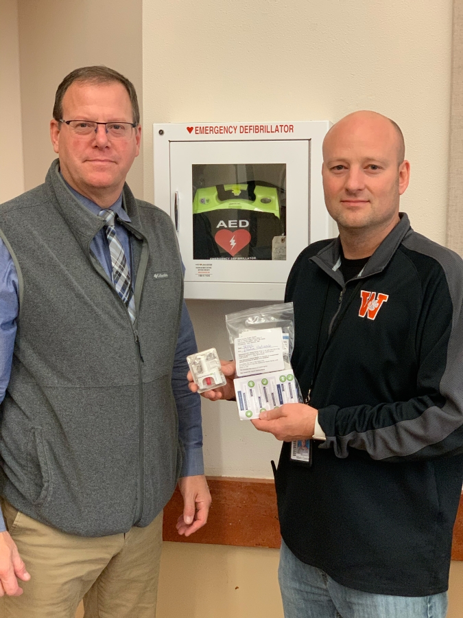 Washougal School District Assistant Superintendent Aaron Hansen, left, and Washougal High School Principal Mark Castle display a dose of medication used to assist people who have experienced an overdose of opioids.