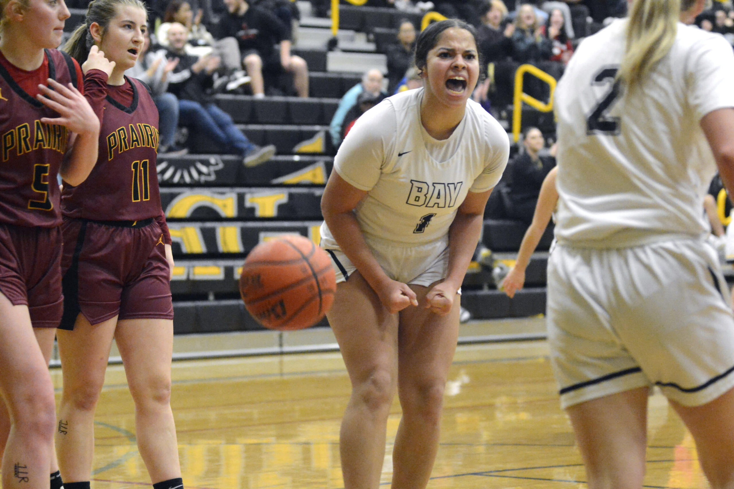 Hudson’s Bay junior Alana Stephens, center, celebrates after teammate Promise Bond, right, made a basket and drew a foul in a non-league game against Prairie on Friday, Dec. 2, 2022, at Hudson’s Bay High School.