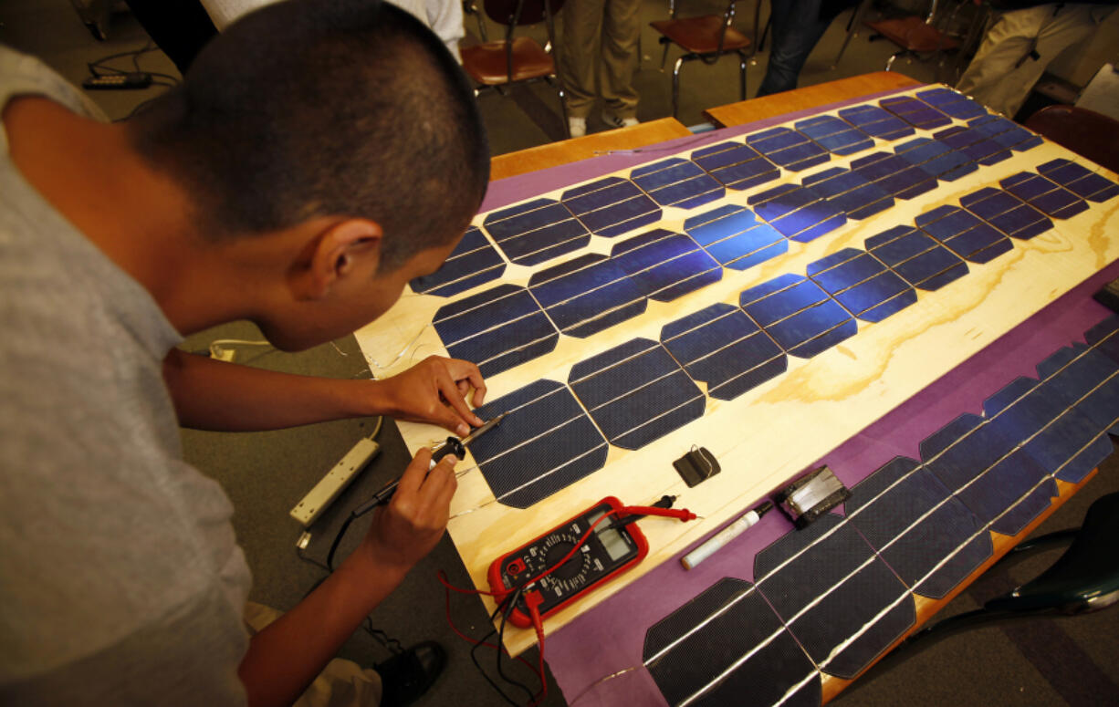 A worker making solar panels in a 2011file image.