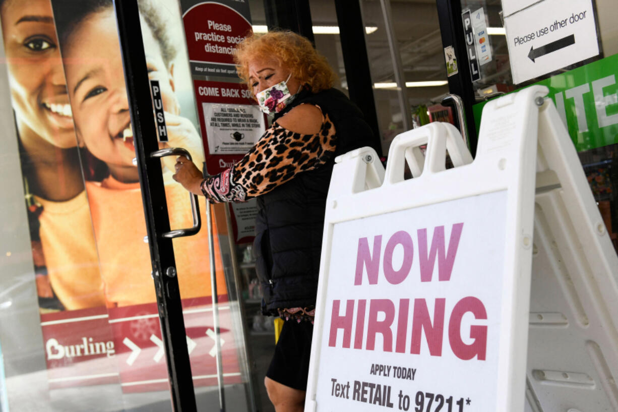 A "now hiring" sign is displayed outside of a Burlington Coat Factory retail store on March 11, 2022, in downtown Los Angeles. (Patrick T.