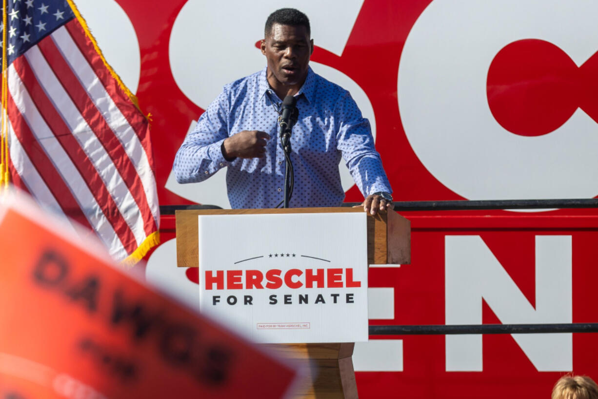 Republican U.S. Senate hopeful Herschel Walker speaks during a rally in Smyrna, Georgia, on Nov. 19, 2022. James Smartwood of ???Tooning Out the News??? recently called Walker for some help retrieving a stolen laptop.