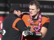 Oregon State head coach Jonathan Smith hugs linebacker Jack Colletto (12) during a Senior Day ceremony prior to an NCAA college football game against Oregon on Saturday, Nov 26, 2022, in Corvallis, Ore. Oregon State won 38-34.