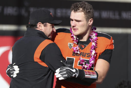 Oregon State head coach Jonathan Smith hugs linebacker Jack Colletto (12) during a Senior Day ceremony prior to an NCAA college football game against Oregon on Saturday, Nov 26, 2022, in Corvallis, Ore. Oregon State won 38-34.