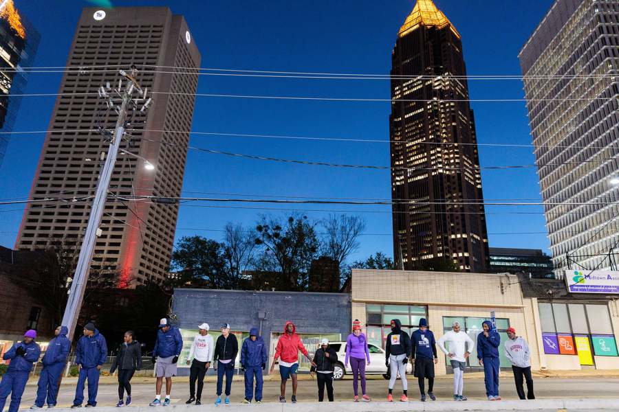Runners with Back on My Feet Atlanta stretch after an early  morning run in Atlanta on Wednesday, Nov. 16, 2022. The nonprofit helps people who are homeless and struggling with addiction build confidence, accountability and other life skills through running.