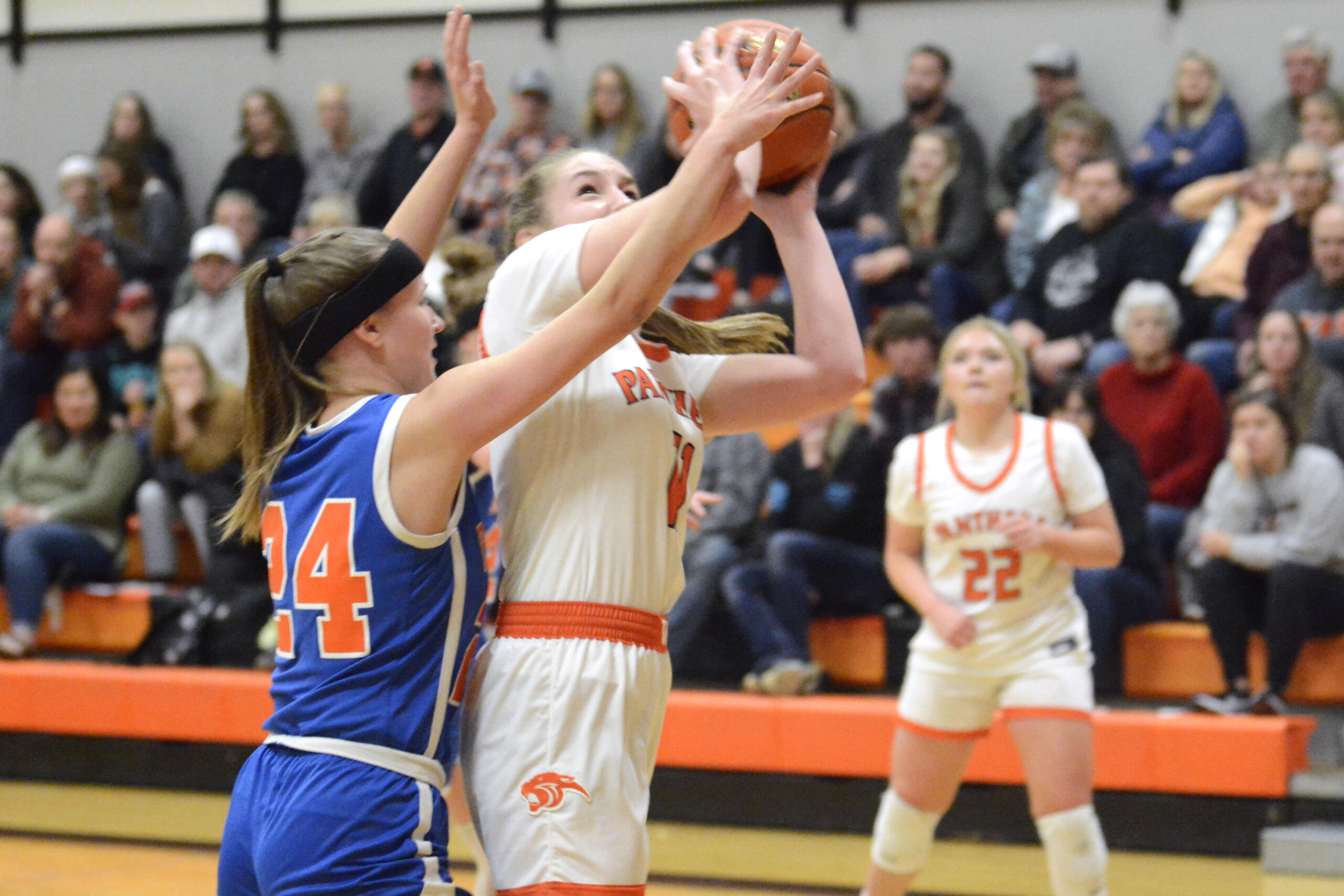 Washougal’s Hadley Jones, center, puts up a shot while being guarded by Ridgefield’s Morgan Goode, left, during a 2A GSHL girls basketball game on Wednesday, Dec. 14, 2022, at Washougal High School.