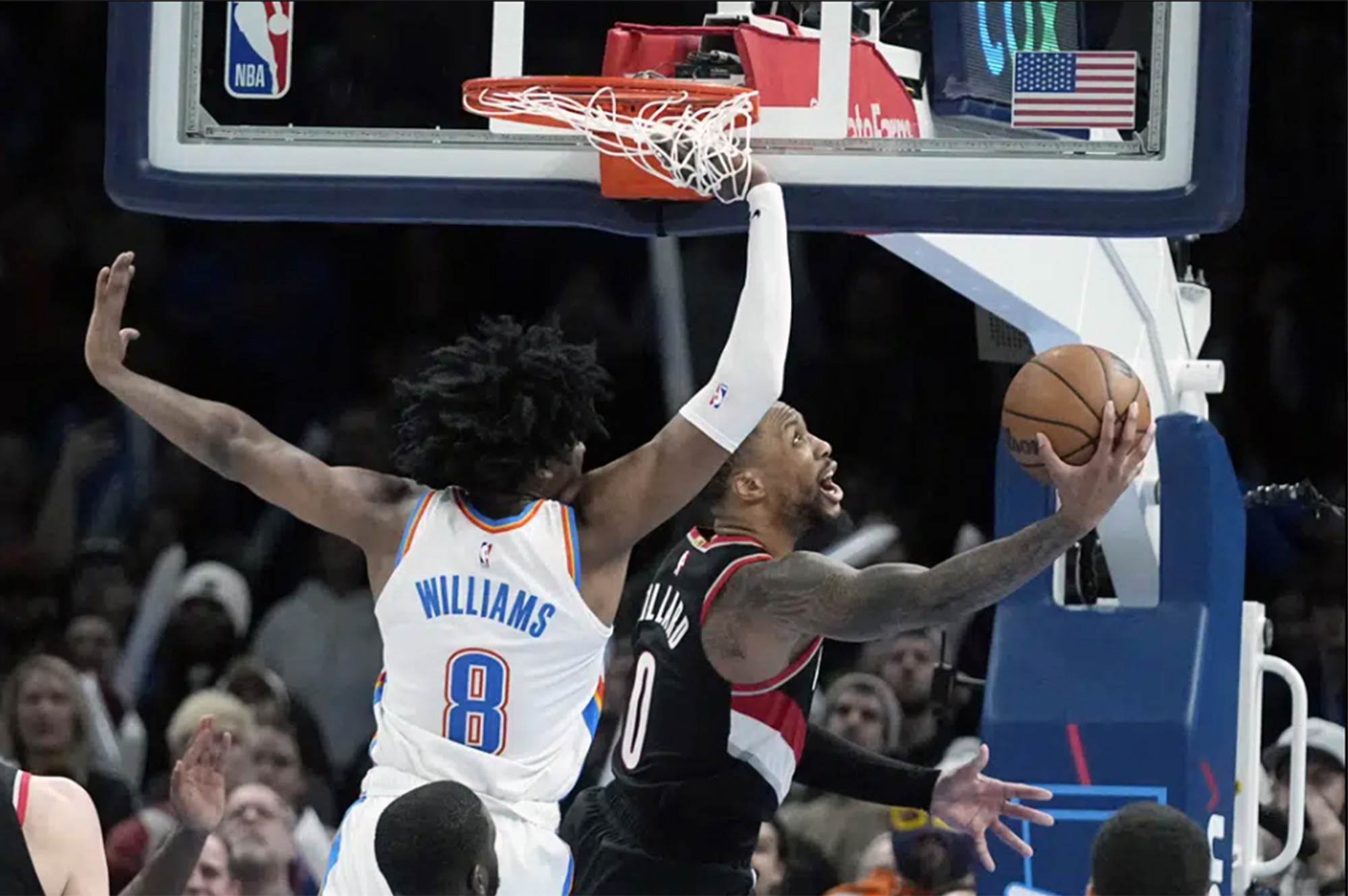 Portland Trail Blazers guard Damian Lillard (0) shoots in front of Oklahoma City Thunder forward Jalen Williams (8) in the second half of an NBA basketball game Monday, Dec. 19, 2022, in Oklahoma City.
