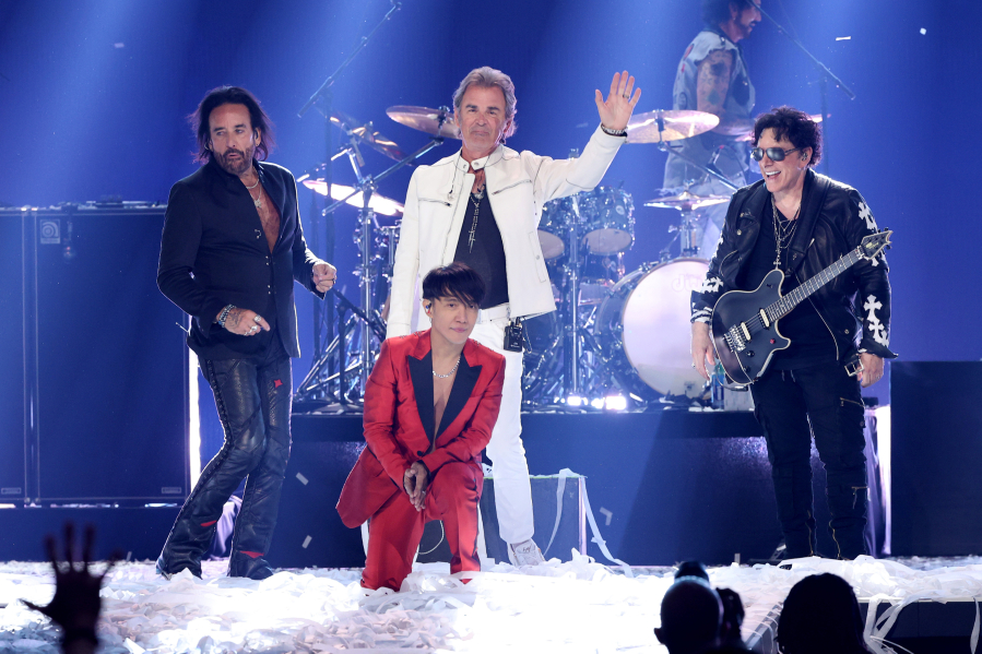 From left, Marco Mendoza, Arnel Pineda, Jonathan Cain, and Neal Schon of Journey perform onstage during the iHeartRadio Music Festival on Sept. 18, 2021, at T-Mobile Arena in Las Vegas.