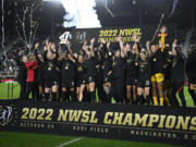 Portland Thorns celebrate with the trophy after winning the NWSL championship against the Kansas City Current on Oct. 29, 2022, in Washington. The owner of the Portland Thorns announced Thursday, Dec. 1, he is putting the club up for sale.