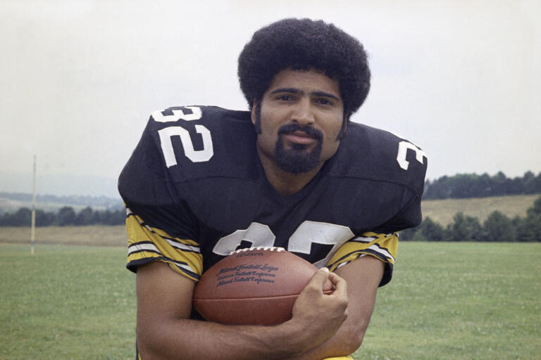 FILE - Pittsburgh Steelers running back Franco Harris is shown in 1973. Franco Harris, the Hall of Fame running back whose heads-up thinking authored “The Immaculate Reception,” considered the most iconic play in NFL history, died Wednesday, Dec. 21, 2022. He was 72.